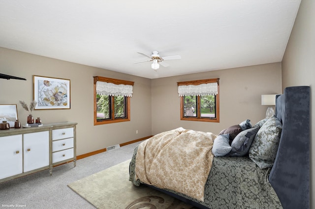 bedroom with carpet flooring, baseboards, and ceiling fan
