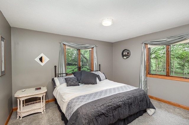 bedroom featuring carpet and baseboards