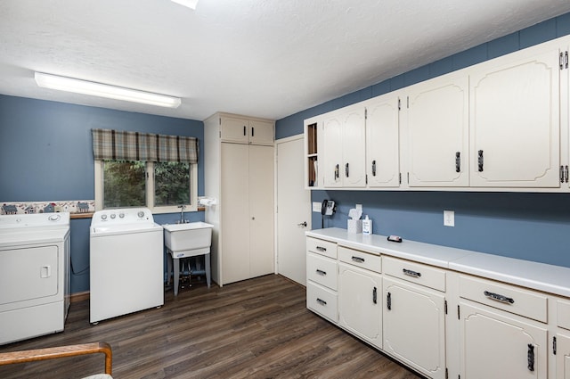 laundry room with washer and dryer, cabinet space, and dark wood-type flooring