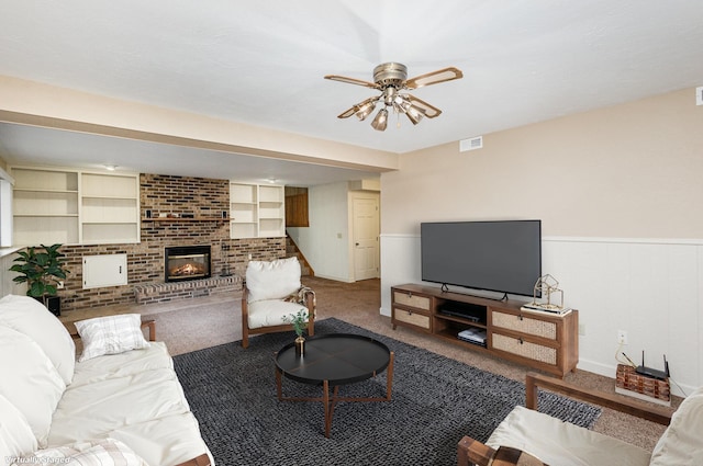 carpeted living room with ceiling fan and a brick fireplace