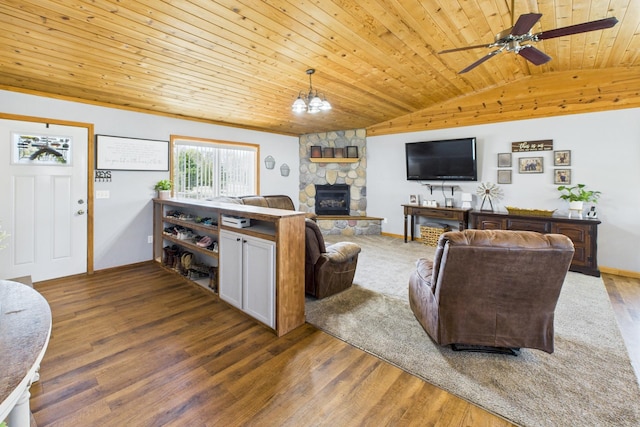 living room featuring vaulted ceiling, wooden ceiling, wood finished floors, ceiling fan, and a fireplace