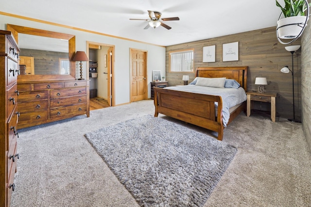bedroom featuring wooden walls, carpet flooring, and a ceiling fan