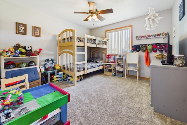 carpeted bedroom featuring a fireplace and a ceiling fan