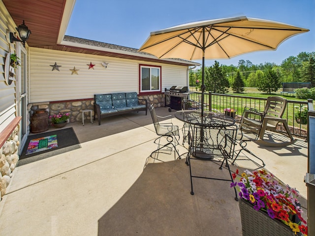 view of patio featuring area for grilling, outdoor dining area, and an outdoor living space