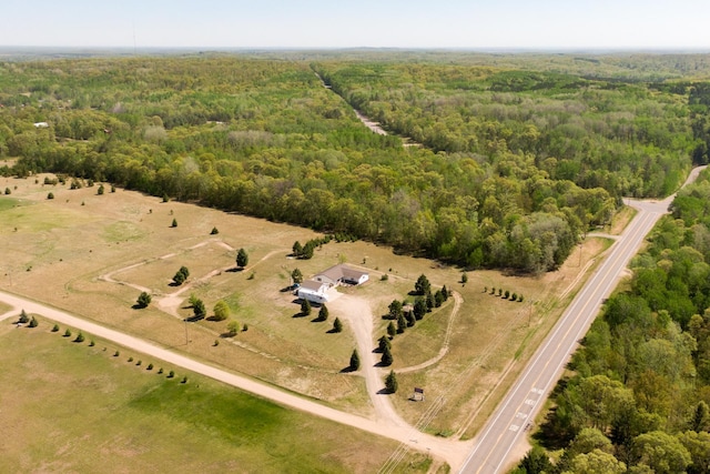 view of rural area featuring a heavily wooded area