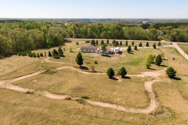 view of property location with rural landscape and a forest