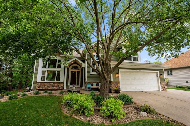 view of front facade with stone siding, concrete driveway, and a front lawn
