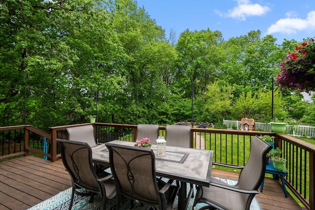 deck with outdoor dining area and a playground