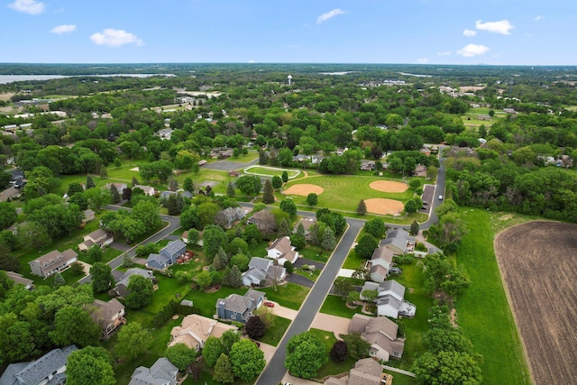 aerial view of residential area featuring a tree filled landscape