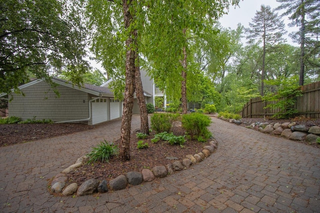 2 Edgcumbe Pl, Saint Paul, MN 55116 - view of side of home featuring decorative driveway and a garage
