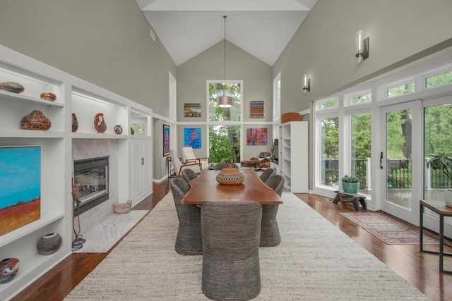 2 Edgcumbe Pl, Saint Paul, MN 55116 - dining room with high vaulted ceiling, a fireplace, and dark wood-style floors