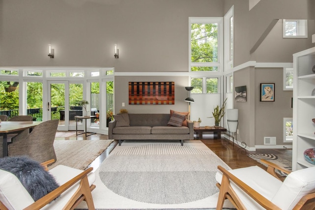 2 Edgcumbe Pl, Saint Paul, MN 55116 - living room featuring a high ceiling, wood finished floors, and baseboards