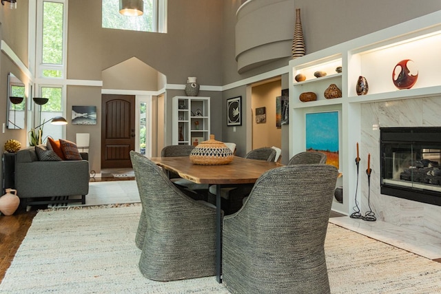 2 Edgcumbe Pl, Saint Paul, MN 55116 - dining room featuring a high ceiling, a fireplace, and wood finished floors