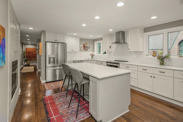 2 Edgcumbe Pl, Saint Paul, MN 55116 - kitchen with stainless steel appliances, wall chimney range hood, recessed lighting, a center island, and a breakfast bar