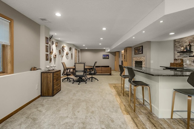 2 Edgcumbe Pl, Saint Paul, MN 55116 - dining space featuring recessed lighting, baseboards, light carpet, a desk, and a glass covered fireplace