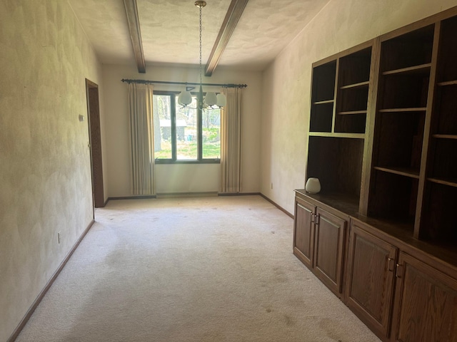 1725 Woodlawn Ave, Owatonna, MN 55060 - unfurnished dining area featuring light colored carpet, beamed ceiling, a chandelier, baseboards, and a textured wall