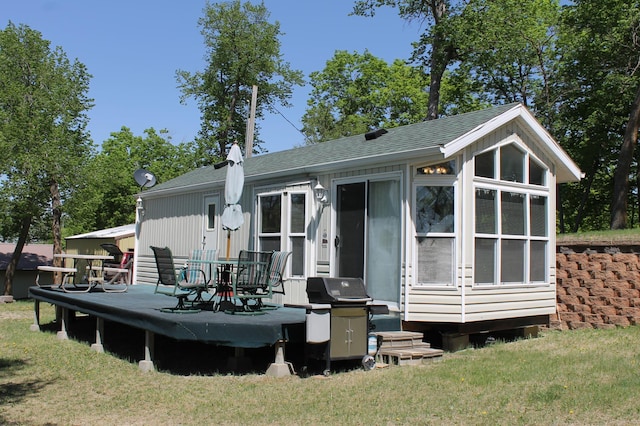 39624 Crane Lake Dr, Clitherall Twp, MN 56515 - back of property featuring roof with shingles, a yard, and a deck