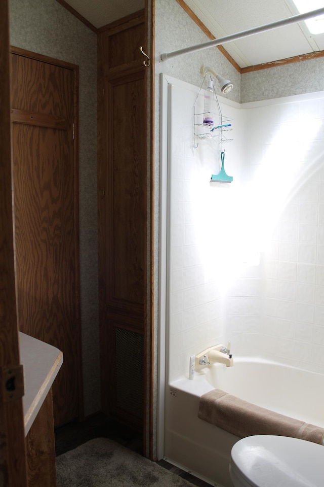 39624 Crane Lake Dr, Clitherall Twp, MN 56515 - bathroom featuring toilet, ornamental molding, shower / tub combination, wallpapered walls, and lofted ceiling