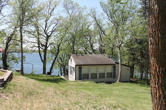 39624 Crane Lake Dr, Clitherall Twp, MN 56515 - view of home's exterior featuring a water view, a lawn, and roof with shingles