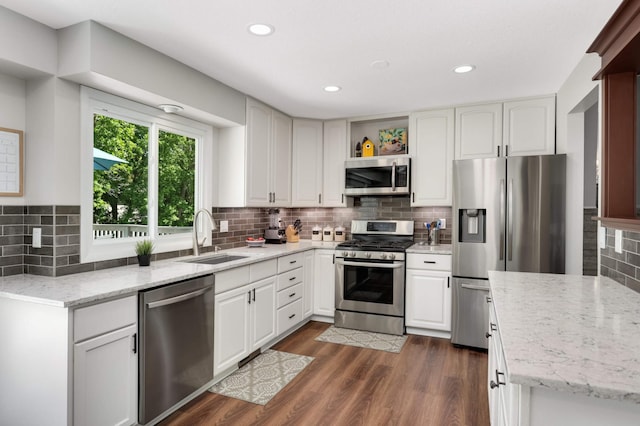 12037 Robin Rd, Maple Grove, MN 55369 - kitchen featuring appliances with stainless steel finishes, a sink, backsplash, dark wood-style floors, and open shelves