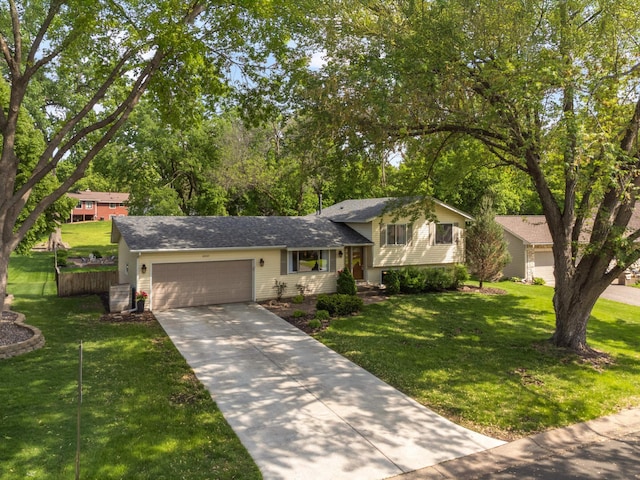 12037 Robin Rd, Maple Grove, MN 55369 - tri-level home with an attached garage, concrete driveway, and a shingled roof