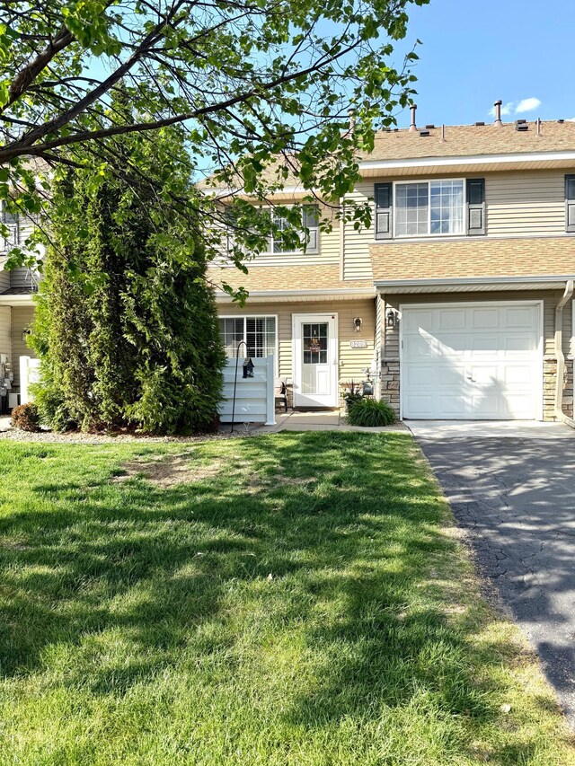 8289 Delaney Dr Unit 24, Inver Grove Heights, MN 55076 - view of property featuring a garage, driveway, and a front yard