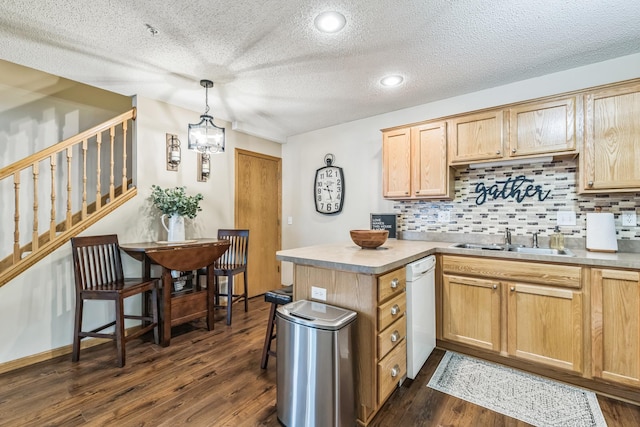 8289 Delaney Dr Unit 24, Inver Grove Heights, MN 55076 - kitchen featuring a sink, white dishwasher, dark wood-style flooring, tasteful backsplash, and a textured ceiling