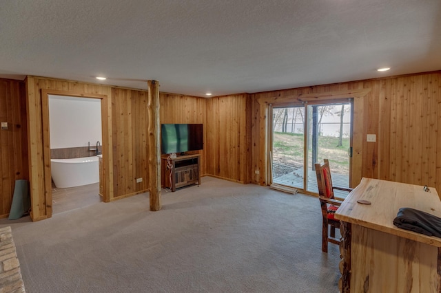 office area with wooden walls, recessed lighting, and light carpet