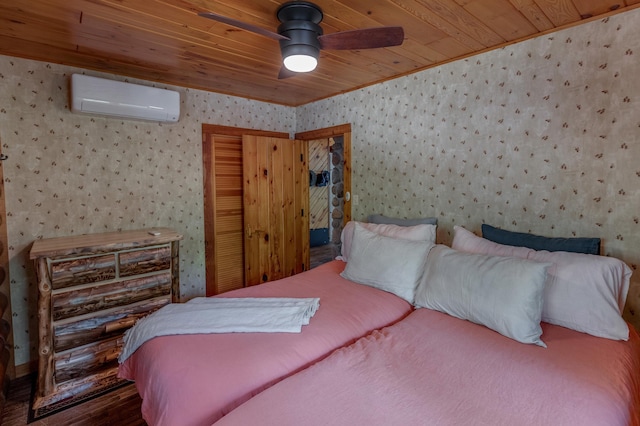 bedroom with wallpapered walls, an AC wall unit, a closet, wooden ceiling, and a ceiling fan