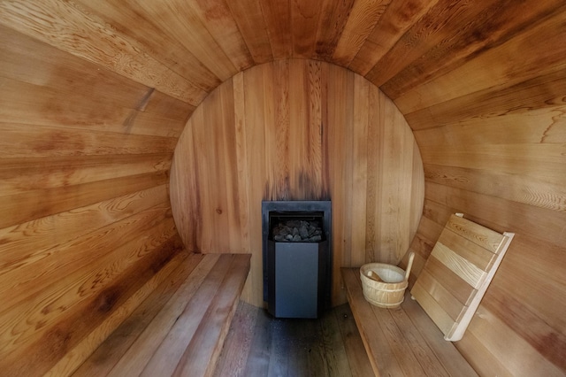 sauna featuring wood walls, hardwood / wood-style floors, and wooden ceiling