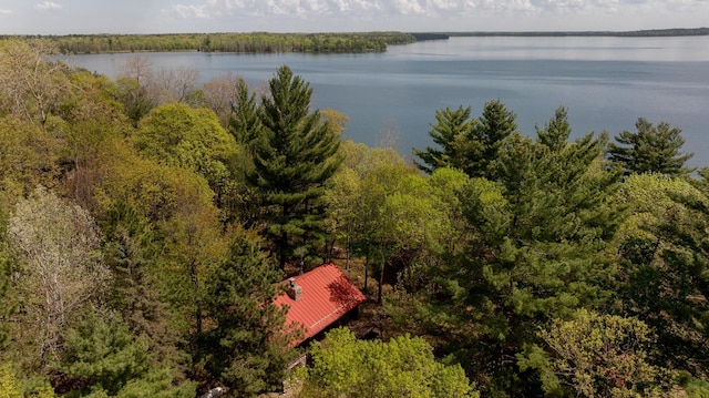 bird's eye view of a nearby body of water and a heavily wooded area