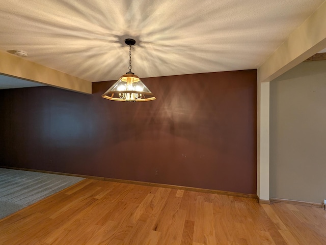 empty room featuring a smoke detector and light wood-style floors