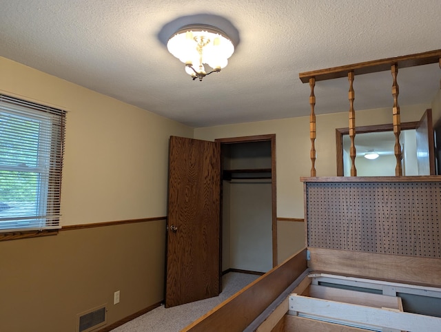bedroom with a closet, a textured ceiling, and baseboards