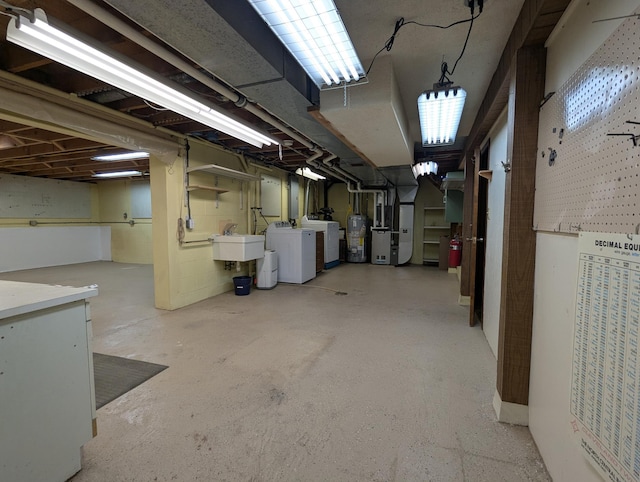 unfinished below grade area with water heater, separate washer and dryer, and a sink