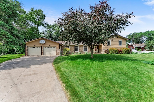 331 Sunset Ln N, Cambridge, MN 55008 - tri-level home with a garage, concrete driveway, a front lawn, and stone siding