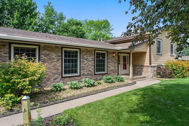 331 Sunset Ln N, Cambridge, MN 55008 - tri-level home with brick siding, a front yard, and roof with shingles