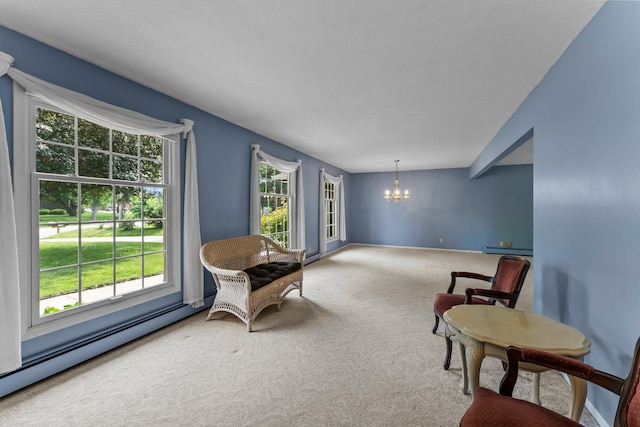 331 Sunset Ln N, Cambridge, MN 55008 - sitting room featuring a chandelier, carpet floors, plenty of natural light, and a baseboard radiator