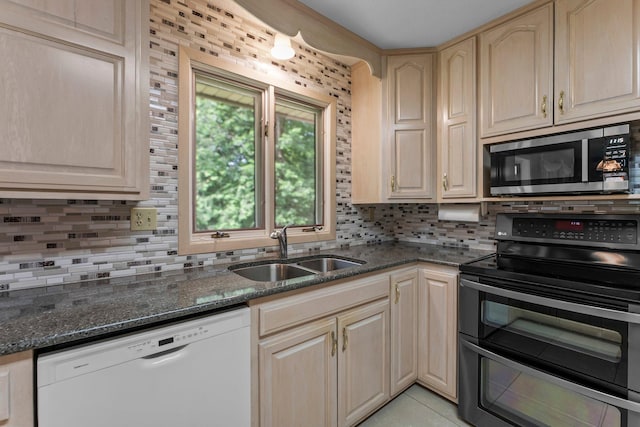 331 Sunset Ln N, Cambridge, MN 55008 - kitchen featuring stainless steel appliances, decorative backsplash, dark stone counters, and light tile patterned floors