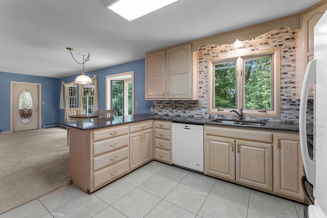 331 Sunset Ln N, Cambridge, MN 55008 - kitchen with white dishwasher, healthy amount of natural light, tasteful backsplash, and a peninsula