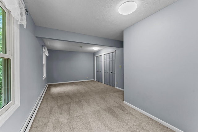 331 Sunset Ln N, Cambridge, MN 55008 - carpeted spare room with baseboard heating, plenty of natural light, and a textured ceiling