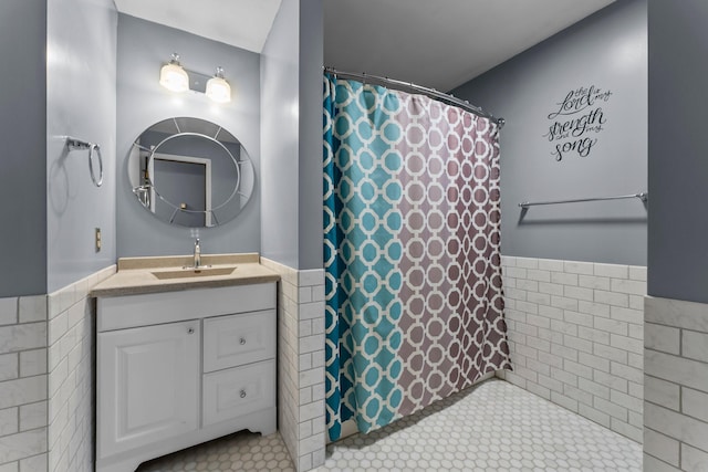 331 Sunset Ln N, Cambridge, MN 55008 - full bathroom with vanity, tile walls, wainscoting, curtained shower, and tile patterned flooring