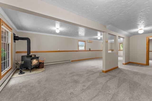 331 Sunset Ln N, Cambridge, MN 55008 - basement featuring a baseboard radiator, carpet floors, a wood stove, a textured ceiling, and a wall mounted air conditioner