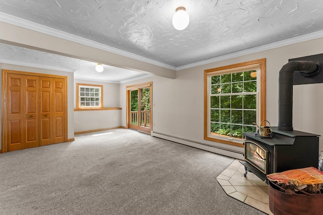 331 Sunset Ln N, Cambridge, MN 55008 - unfurnished living room with baseboard heating, a wood stove, plenty of natural light, carpet floors, and crown molding