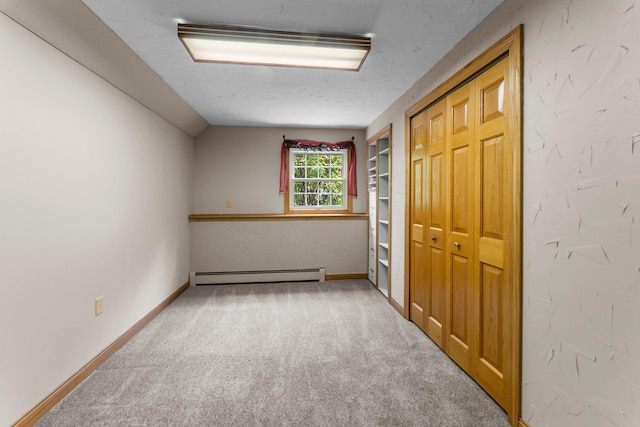 331 Sunset Ln N, Cambridge, MN 55008 - carpeted empty room featuring a baseboard heating unit and vaulted ceiling