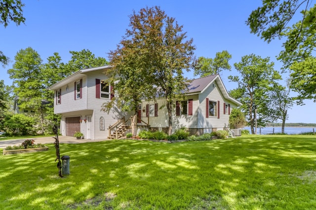 20473 Leisure Dr, Pelican Rapids, MN 56572 - view of front of home featuring driveway, a water view, an attached garage, and a front lawn