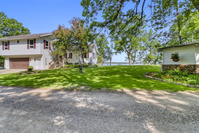 20473 Leisure Dr, Pelican Rapids, MN 56572 - view of grassy yard featuring stairway, an attached garage, and driveway