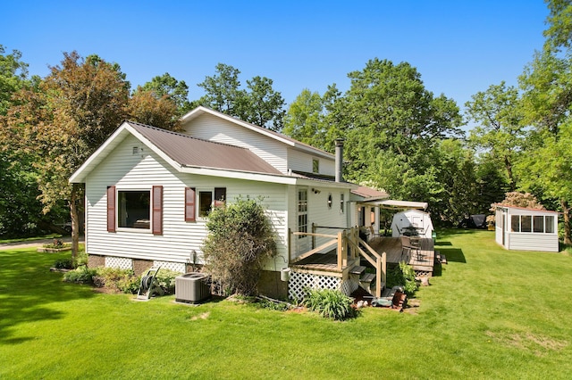 20473 Leisure Dr, Pelican Rapids, MN 56572 - rear view of house featuring a wooden deck, a lawn, and central AC