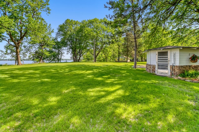 20473 Leisure Dr, Pelican Rapids, MN 56572 - view of green lawn with a water view and an outbuilding