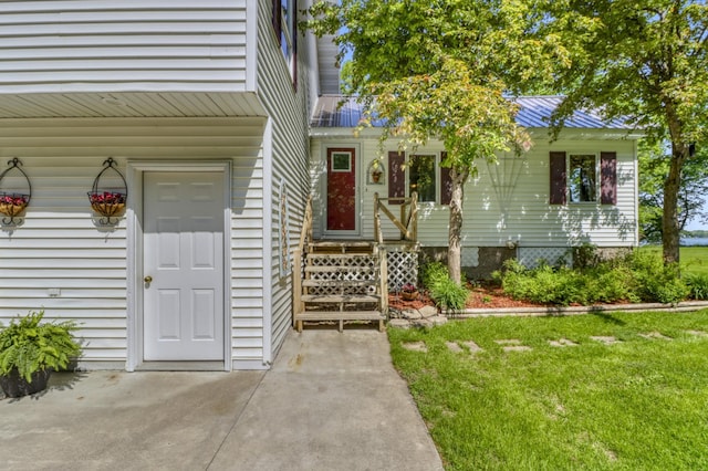 20473 Leisure Dr, Pelican Rapids, MN 56572 - view of exterior entry with a yard