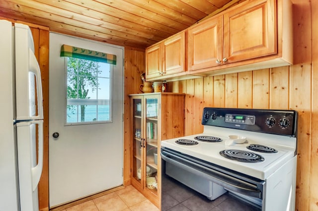 20473 Leisure Dr, Pelican Rapids, MN 56572 - kitchen with white appliances, wood ceiling, light tile patterned flooring, wood walls, and light brown cabinets